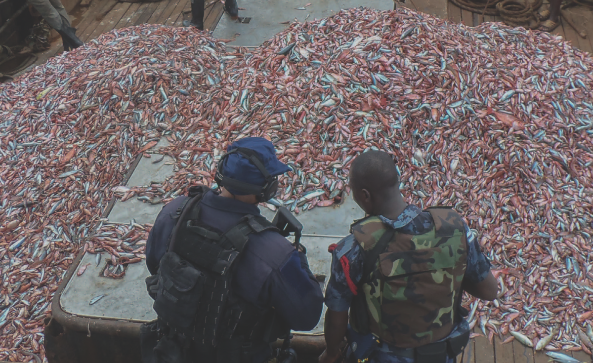 A U.S. Coast Guard officer and a Ghanaian navy sailor inspect a fishing vessel suspected of illegal fishing. Photo: Kwabena Akuamoah-Boateng, U.S. Embassy Ghana/Released