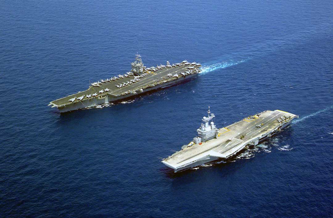 USS Enterprise (left), the first nuclear-powered aircraft carrier, and Charles de Gaulle (right) - Credit: U.S. Navy photo by Photographer's Mate Airman Doug Pearlman